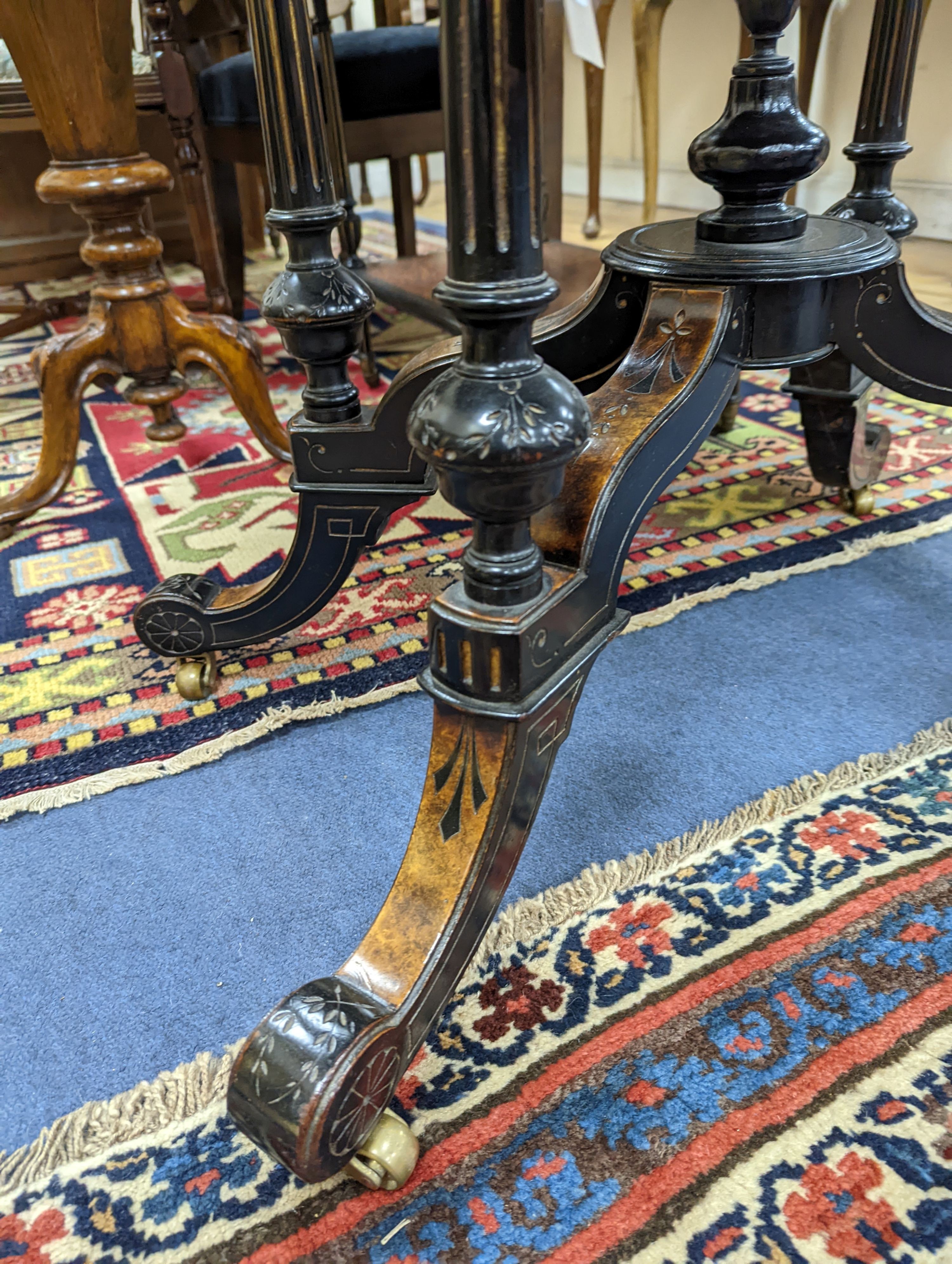 A late Victorian part ebonised oval Amboyna centre table, width 90cm, depth 60cm, height 69cm